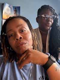 two women posing for a photo in an office